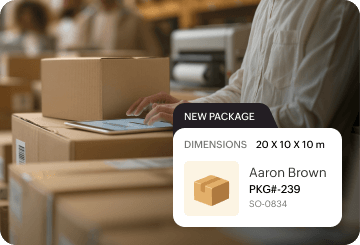 Warehouse worker processing a new package shipment in Zoho Inventory.